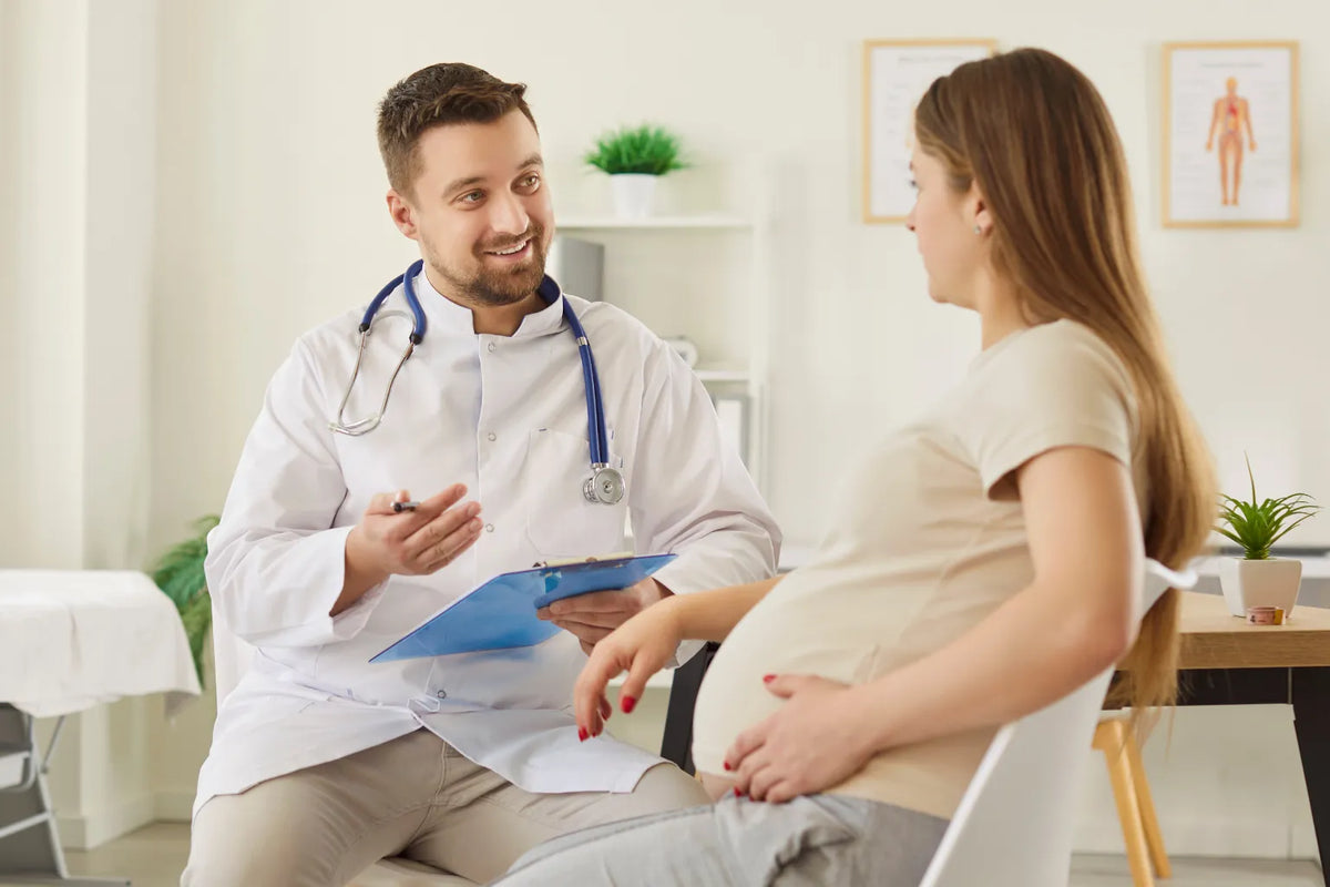 Pregnant woman interviewing her obstetrician during a prenatal visit