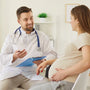 Pregnant woman interviewing her obstetrician during a prenatal visit