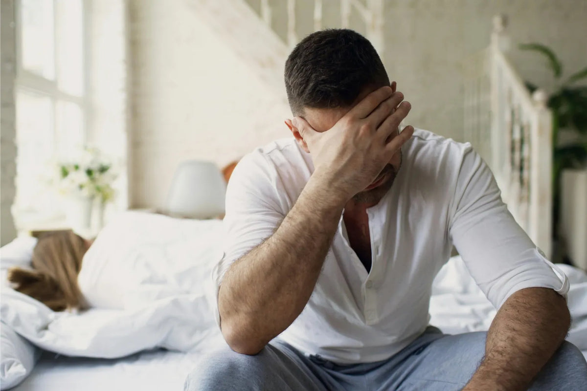 Father holding newborn baby experiencing postpartum depression symptoms