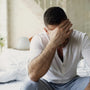 Father holding newborn baby experiencing postpartum depression symptoms