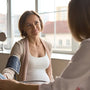 Pregnant woman monitoring blood pressure at home to detect early signs of preeclampsia