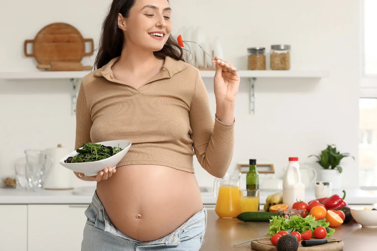 Pregnant woman eating a nutritious meal with eggs, salmon, and leafy greens for fetal brain development