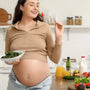 Pregnant woman eating a nutritious meal with eggs, salmon, and leafy greens for fetal brain development