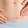 Doctor explaining C-section indications and risks to a pregnant patient